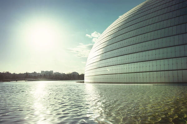 Sun and a partial view of Beijing Opera building with pool, Beijing, China, Asia