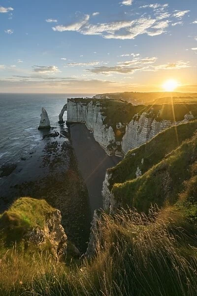 Sun rays at dawn at the cliffs, Etretat, Normandy, France, Europe
