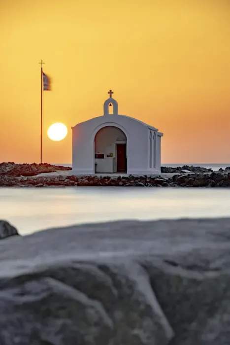 Framed Print : Sun rising over the iconic Agios Nikolaos church and cliffs, Georgioupolis, Crete island, Greek Islands, Greece, Europe