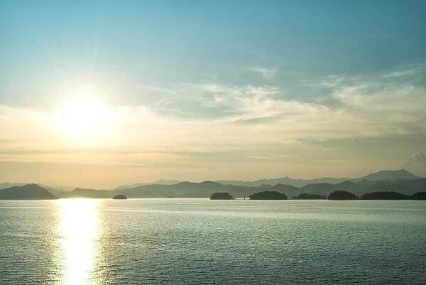 The sun about to set over the mountains surrounding Qiandao (Thousand Islands) Lake