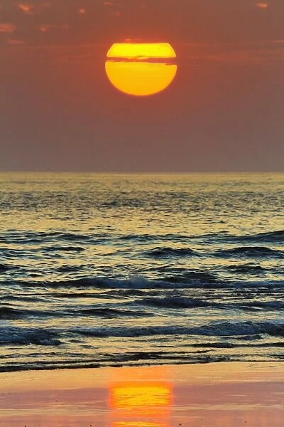 The sun setting off Playa Guiones surf beach, Nosara, Nicoya Peninsula, Guanacaste Province, Costa Rica, Central America