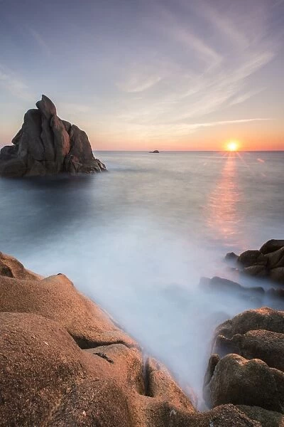 The sun setting behind the rocks of the peninsula of Capo Testa, by Santa Teresa di Gallura, Sardinia, Italy, Mediterranean, Europe
