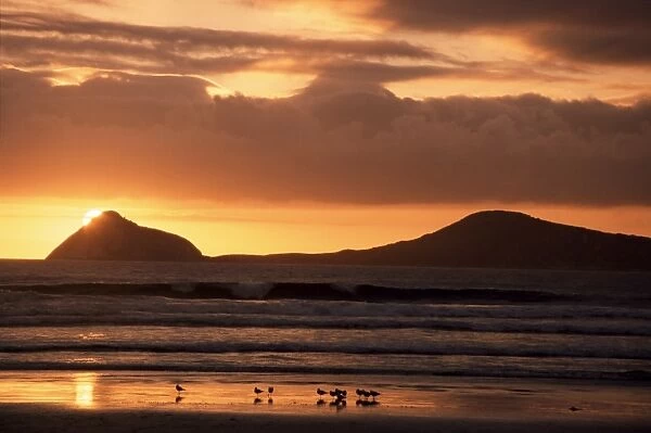 Sun sinks behind small islands, Wilsons Promontory National Park, Victoria