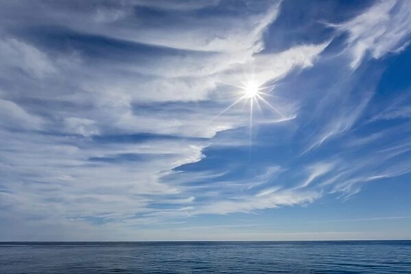 Sunburst in blue sky near the Cumberland Peninsula, Baffin Island, Nunavut, Canada, North America