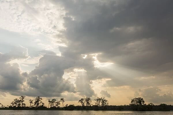 Sunburst through clouds on the Pacaya River, Upper Amazon River Basin, Loreto, Peru