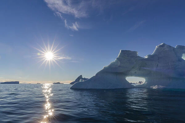 Sunburst on iceberg in De Dodes Fjord (Fjord of the Dead), Baffin Bay, Greenland