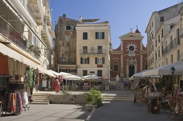 A sunny square with a church, pavement cafes, and small shops, in old Corfu. Island of Corfu, Ionian Islands, Greek Islands, Greece, Europe