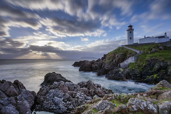 Sunrise over the Atlantic Ocean and Fanad Head Lighthouse in County Donegal Ireland