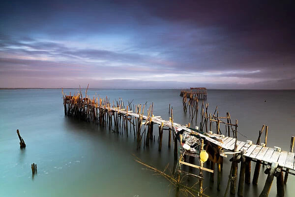 Sunrise and clouds on the Palafito Pier in the Carrasqueira Natural Reserve of Sado River