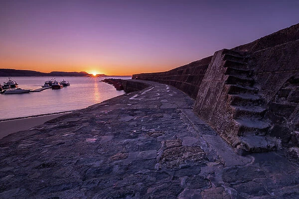 Sunrise at the harbour wall known as The Cobb in Lyme Regis, Dorset, England, United Kingdom, Europe