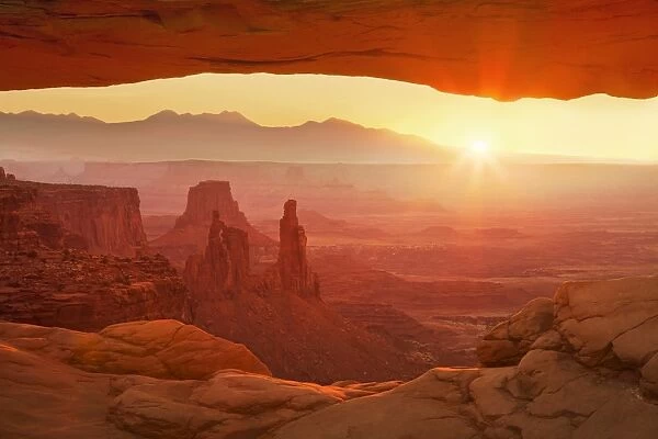 Sunrise over La Sal Mountains, Washer Woman Arch, and Mesa Arch, Island in the Sky, Canyonlands National Park, Utah, United States of America, North America