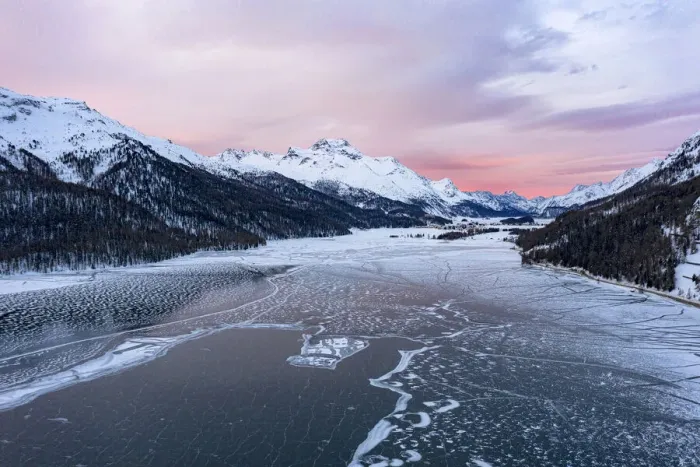 Framed Print : Sunrise on the snowcapped mountains and frozen Lake Silvaplana, aerial view, Maloja
