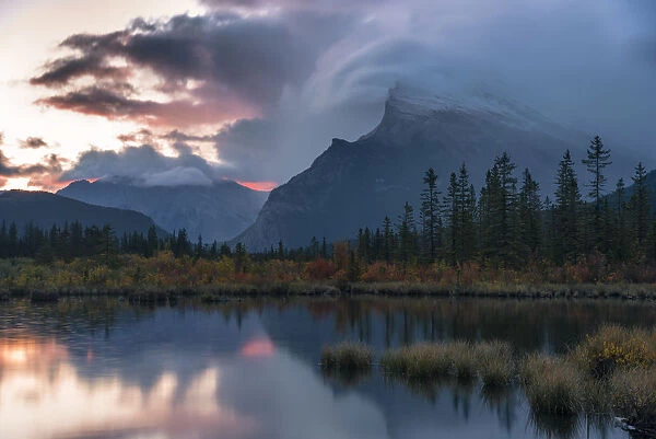 Sunrise and storm clouds at Vermillion Lakes with Mount Rundle in autumn, Banff National