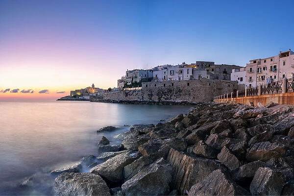 Sunrise over Vieste old town on headland by the sea, Foggia province