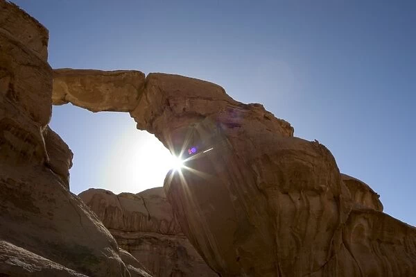 Suns rays, natural rock arch, desert scenery, Wadi Rum, Jordan, Middle East