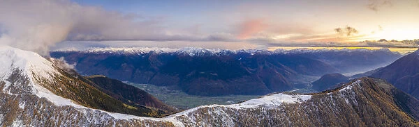 Sunset on the autumnal landscape of Scermendone Alp and Orobie Alps, aerial view by drone