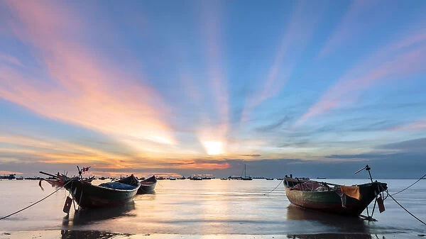 Sunset from Front beach, Vung Tau with pink clouds and small fishing boats in the