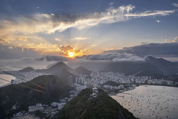 Sunset over the city skyline and Rios mountains and beaches from the summit of Sugar Loaf mountain, Rio de Janeiro, Brazil, South America
