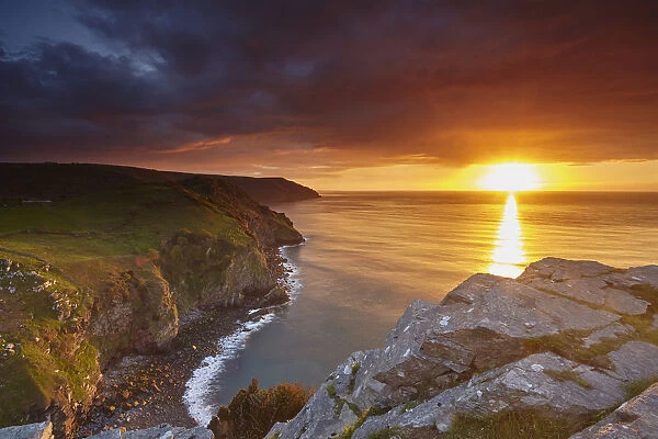 Sunset over coastal cliffs seen from the Valley of Rocks, Lynton, Exmoor National Park
