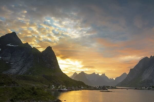 Sunset on the fishing village surrounded by rocky peaks and sea, Reine, Nordland county