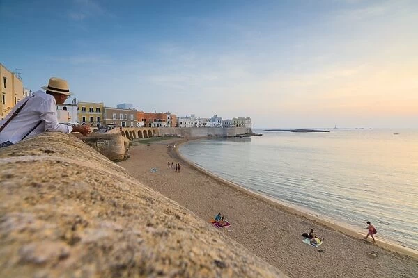 Sunset frames the beach and the turquoise sea, Gallipoli, Province of Lecce, Apulia