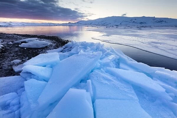 Sunset over frozen Jokulsarlon Glacial Lagoon in winter, South Iceland, Polar Regions