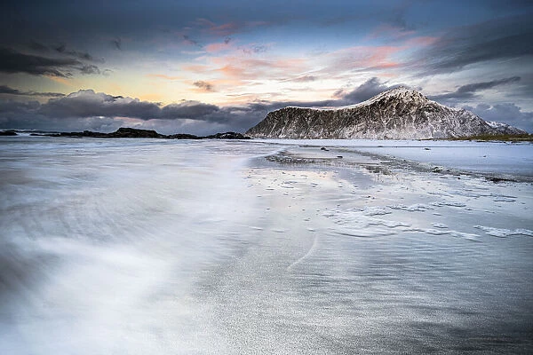Sunset over frozen waves of the Arctic Sea, Skagsanden beach, Flakstad, Nordland county