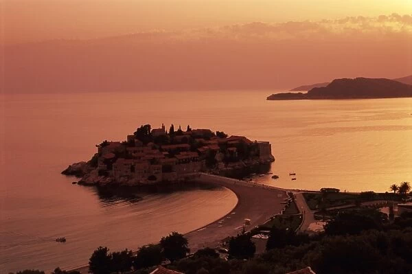Sunset over island of Sveti Stefan, Sveti Stefan, The Budva Riviera, Montenegro, Europe