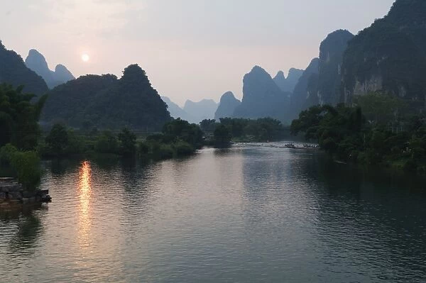 Sunset over karst limestone scenery on the Li river (Lijiang) in Yangshuo