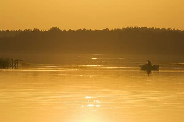 Sunset on lake and fishing boat