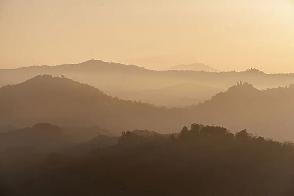 Sunset light reflected in the mist on countryside hills, Emilia Romagna, Italy, Europe