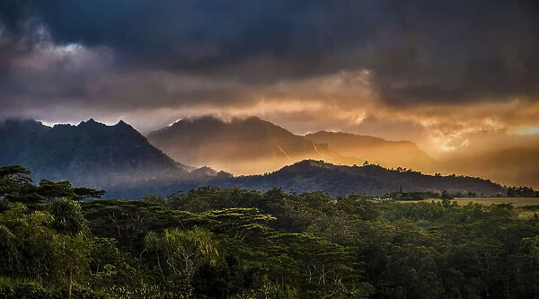 Sunset light streaking through mountains, Kauai, Hawaii, United States of America