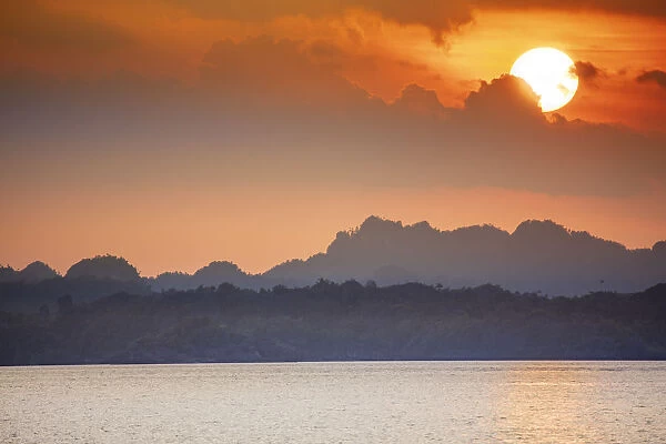 Sunset over limestone karst islands, Raja Ampat, West Papua, Spice Islands, Indonesia