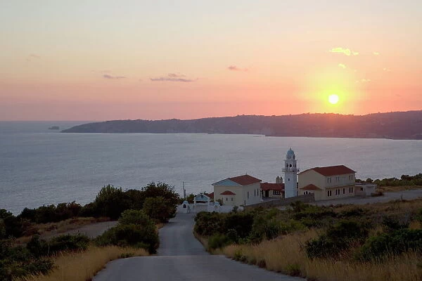 Sunset over Lourdata Bay, monastery prominent, near Lourdata, Kefalonia (Kefallonia, Cephalonia), Ionian Islands, Greek Islands, Greece, Europe
