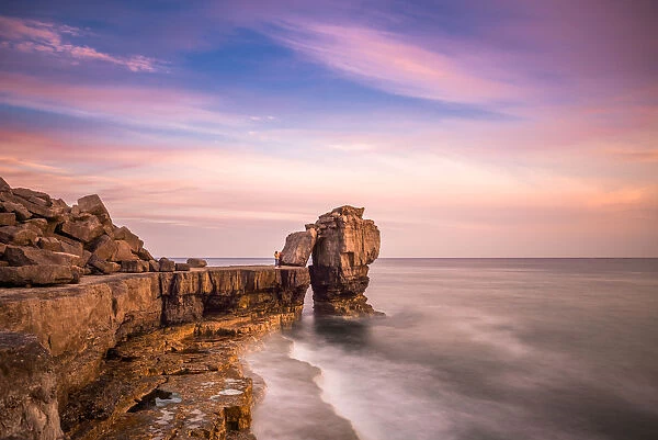 Sunset at Pulpit Rock, limestone sea stack on heavily quarried coast of Portland Bill