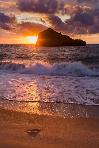 Sunset over Roche Ronde rock off the coast of Biarritz, Pyrenees Atlantiques, Aquitaine