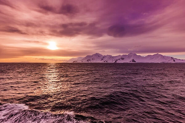 Sunset and a scenic view of the glacial ice and floating icebergs in Antarctica