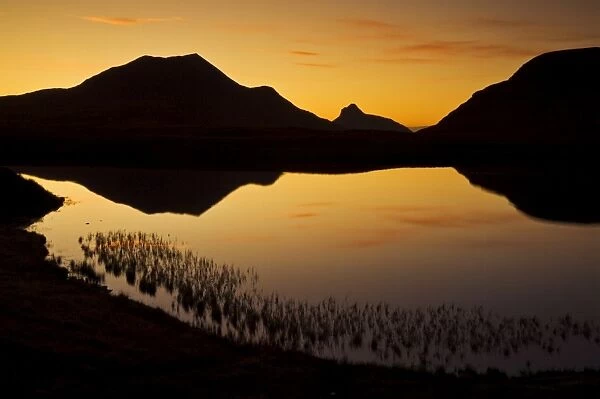 Sunset silhouette at Lochan an Ais, Inverpolly, Sutherland, north west Scotland