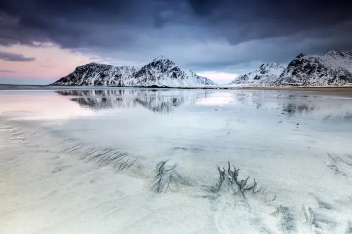 Framed Print : Sunset on Skagsanden beach surrounded by snow covered mountains reflected in the cold sea Framed Print : Sunset on Skagsanden beach surrounded by snow covered mountains reflected in the cold sea