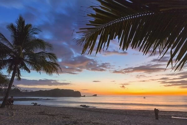 Sunset by the southern headland of beautiful Playa Pelada beach, Nosara, Nicoya Peninsula, Guanacaste Province, Costa Rica