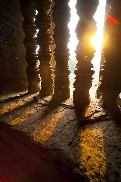 Sunset through stone pillars at Angkor Wat, Angkor Temple Complex, UNESCO World Heritage Site, Siem Reap Province, Cambodia, Indochina, Southeast Asia, Asia