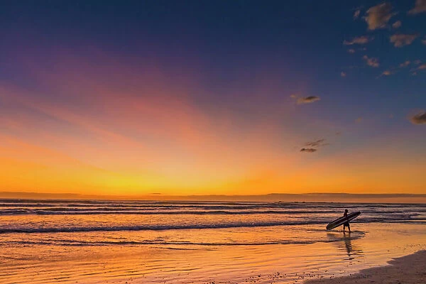 Sunset & surfer at Playa Guiones beach, Nosara, Nicoya Peninsula, Guanacaste Province, Costa Rica, Central America