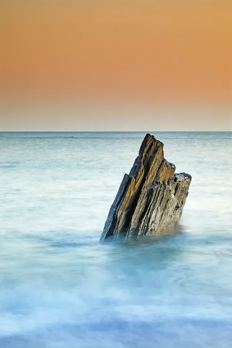Framed Print : A sunset view of a jagged tooth-like rock, surrounded by surging sea at Ayrmer Cove, a remote cove near Kingsbridge, south coast of Devon, England, United Kingdom, Europe Framed Print : A sunset view of a jagged tooth-like rock, surrounded by surging sea at Ayrmer Cove, a remote cove near Kingsbridge, south coast of Devon, England, United Kingdom, Europe