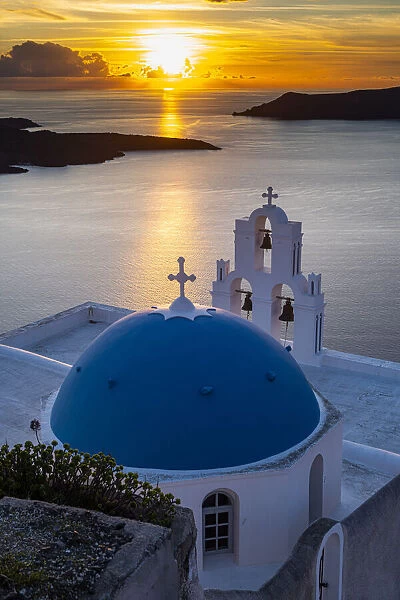 Sunset over the volcanic islands of Santorini and Anastasi Orthodox Church at sunset