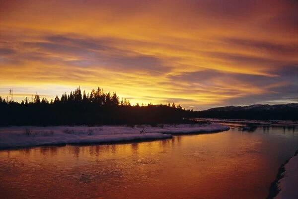Sunset over a warm river in winter