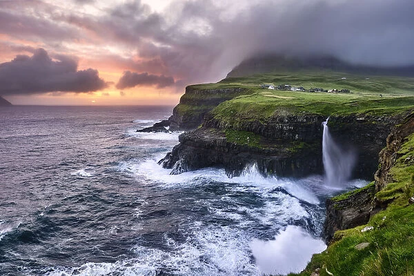 Sunset at the waterfall and cliffs of Gasadalur, Faroe Islands, Denmark, Europe