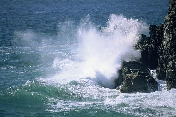 Surf crashing on the rocks at Cape Byron, most easterly point, named by Captain Cook after poets grandfather, New South Wales