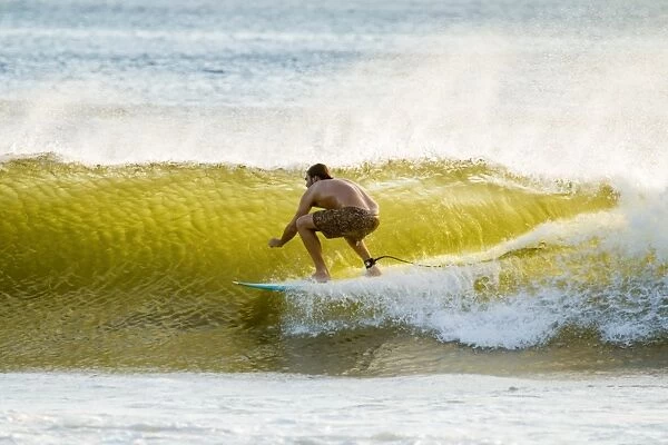 Surfer in barrel of this famous shore break wave near San Juan del Sur, Playa Maderas Beach, San Juan del Sur, Rivas, Nicaragua, Central America