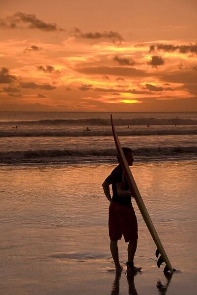 Surfer at sunset, Kuta Beach, Bali, Indonesia, Southeast Asia, Asia