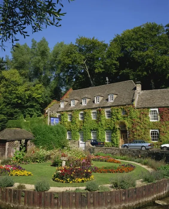 Framed Print : The Swan Hotel and garden full of summer flowers at Bibury, in the Cotswolds Framed Print : The Swan Hotel and garden full of summer flowers at Bibury, in the Cotswolds